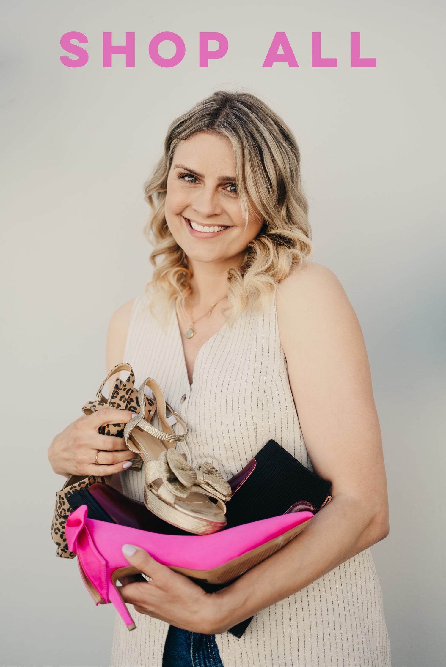 Founder Laura Schofield holding her large size shoes for women.