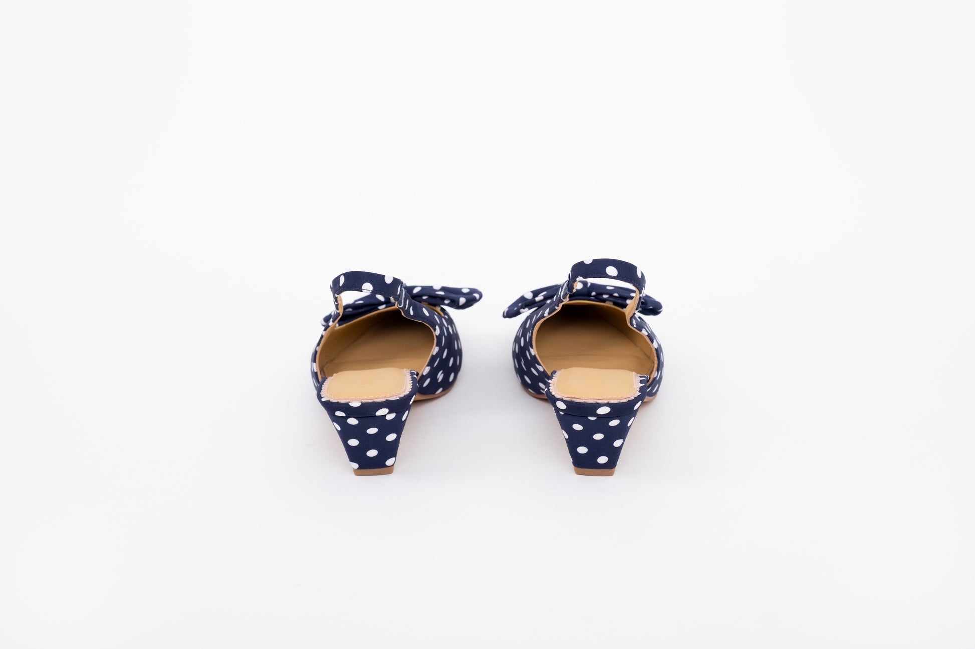 Back shot of navy polka dot kitten heeled slingback shoe in lwomens arger sizes 8-12