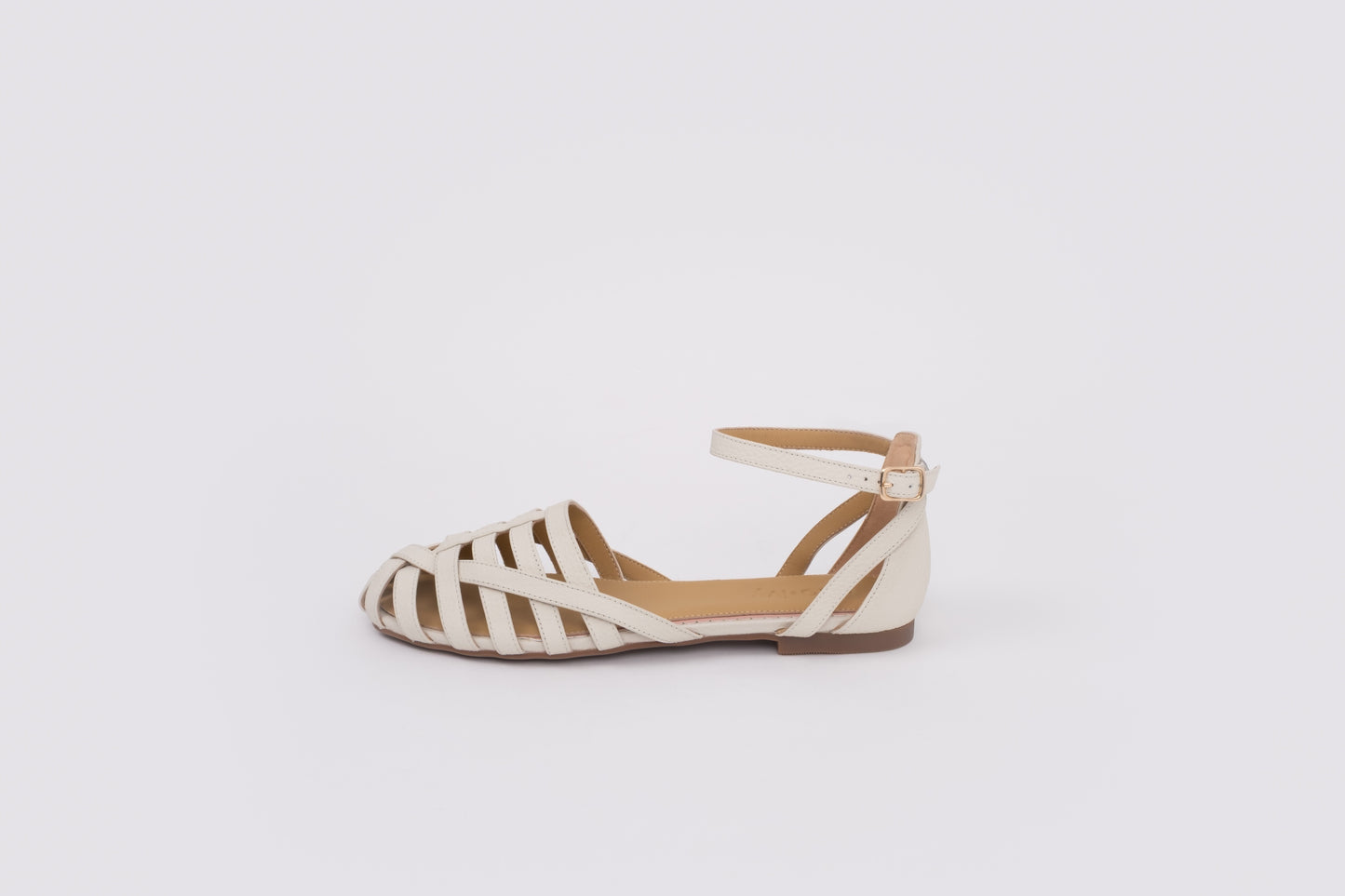 size 9 womens Beige flat shoe with zebra pattern sole on a white background