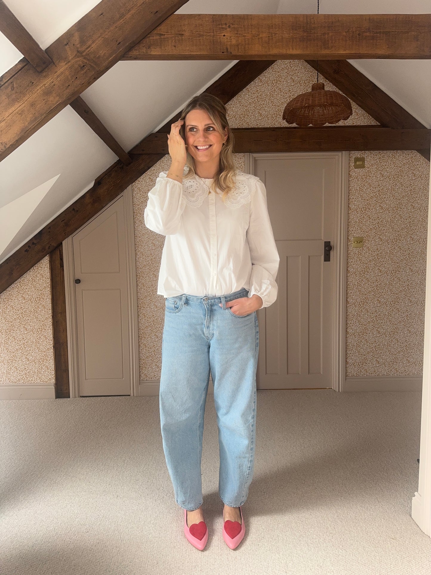 Tall woman wearing large sized pink and red love heart flat shoes in UK sizes 8 9 10 11 12, standard and wide fit
