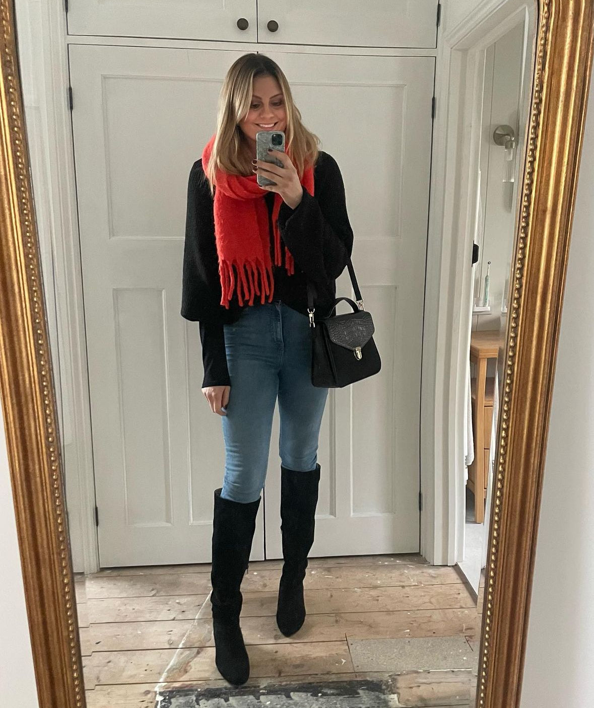 Woman modelling Black knee high suede heeled boots. Available in larger UK sizes 8-12