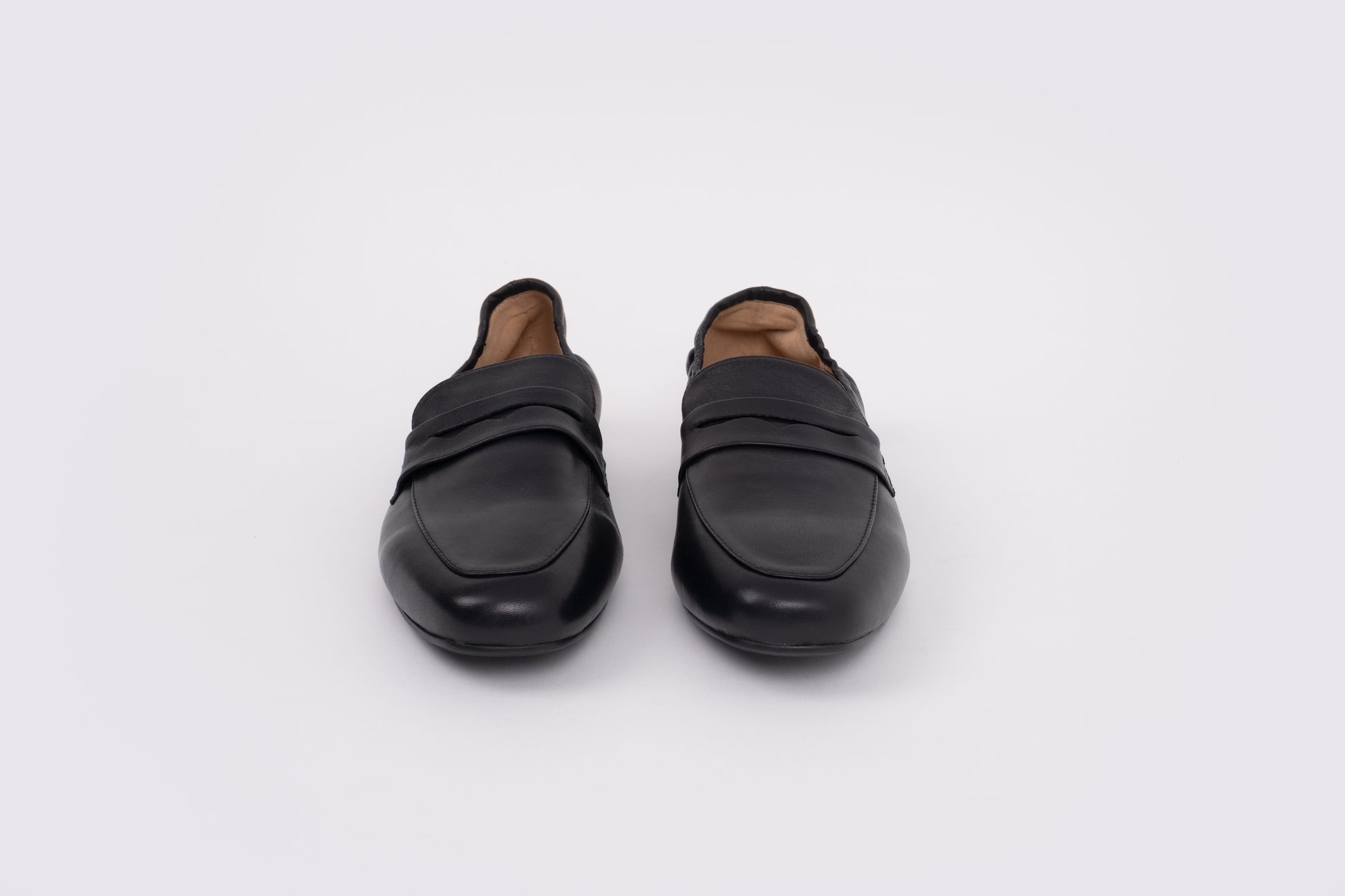 Large sized womens 42-46 Pair of black loafers on a white background