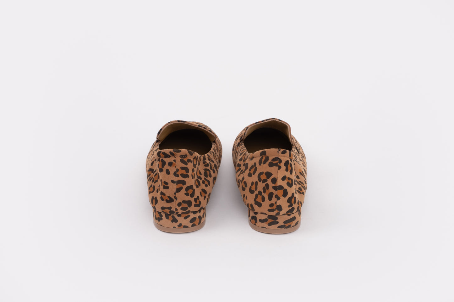 Back shot of womens size 9 large sized Pair of leopard print slippers on a white background