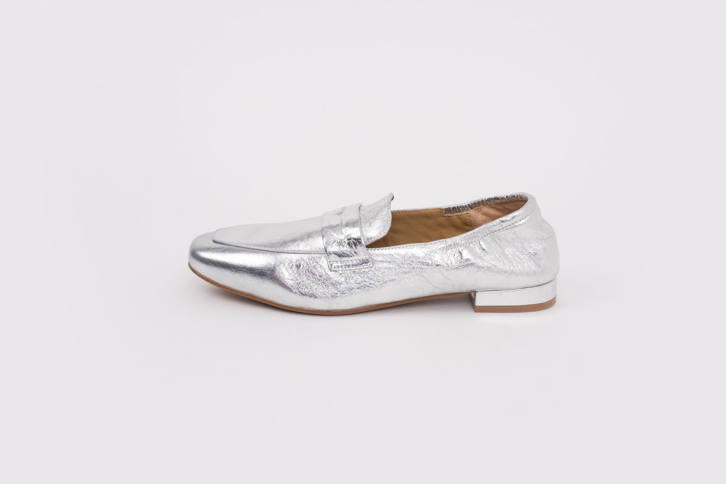 large size 9 womens Silver loafer shoe on a white background