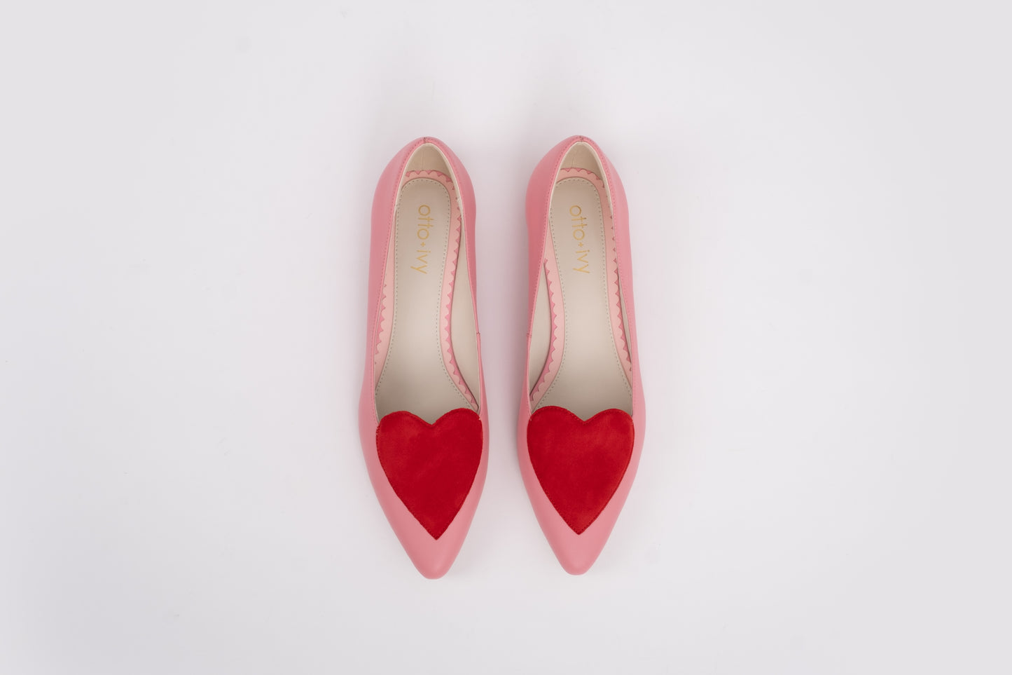 Aerial shot of womens large sized pink and red love heart flat shoes in large sizes 42 43 44 45 46