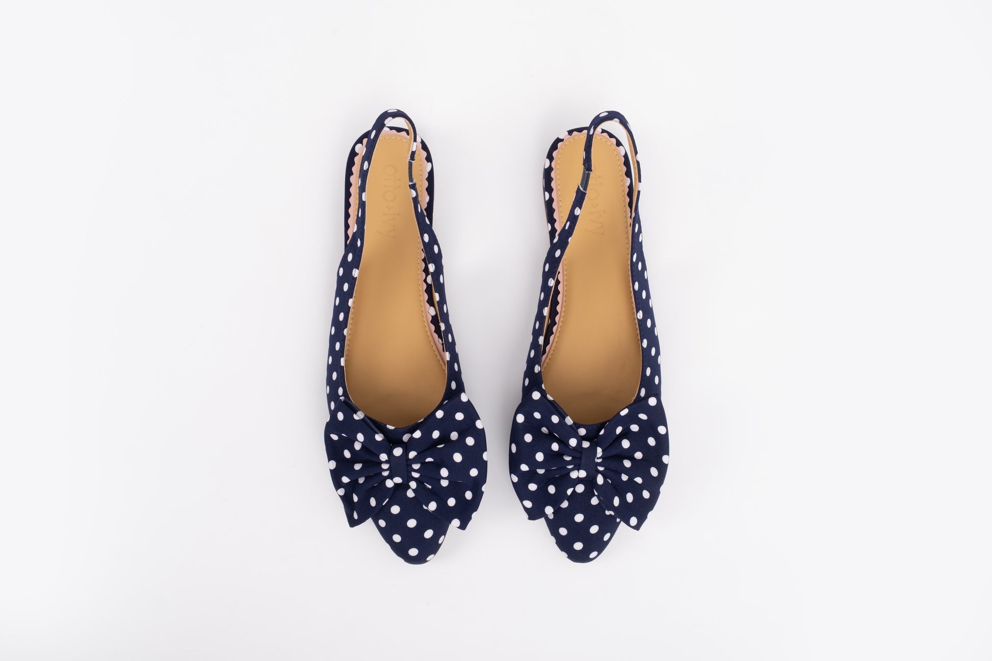 Aerial shot of womens navy polka dot bow slingback shoe in larger sizes 8-12