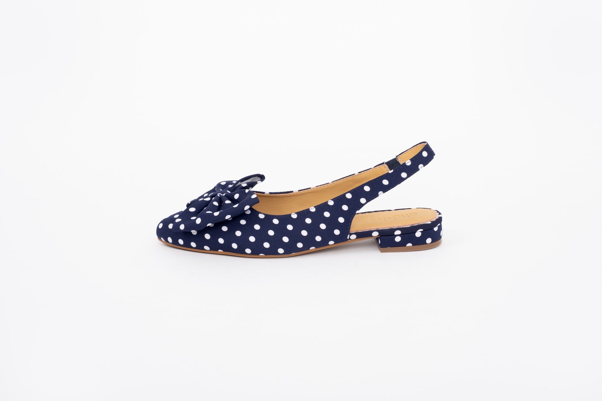 Side shot of navy blue polka dot bow slingback flat shoe in European larger womens sizes 42-46
