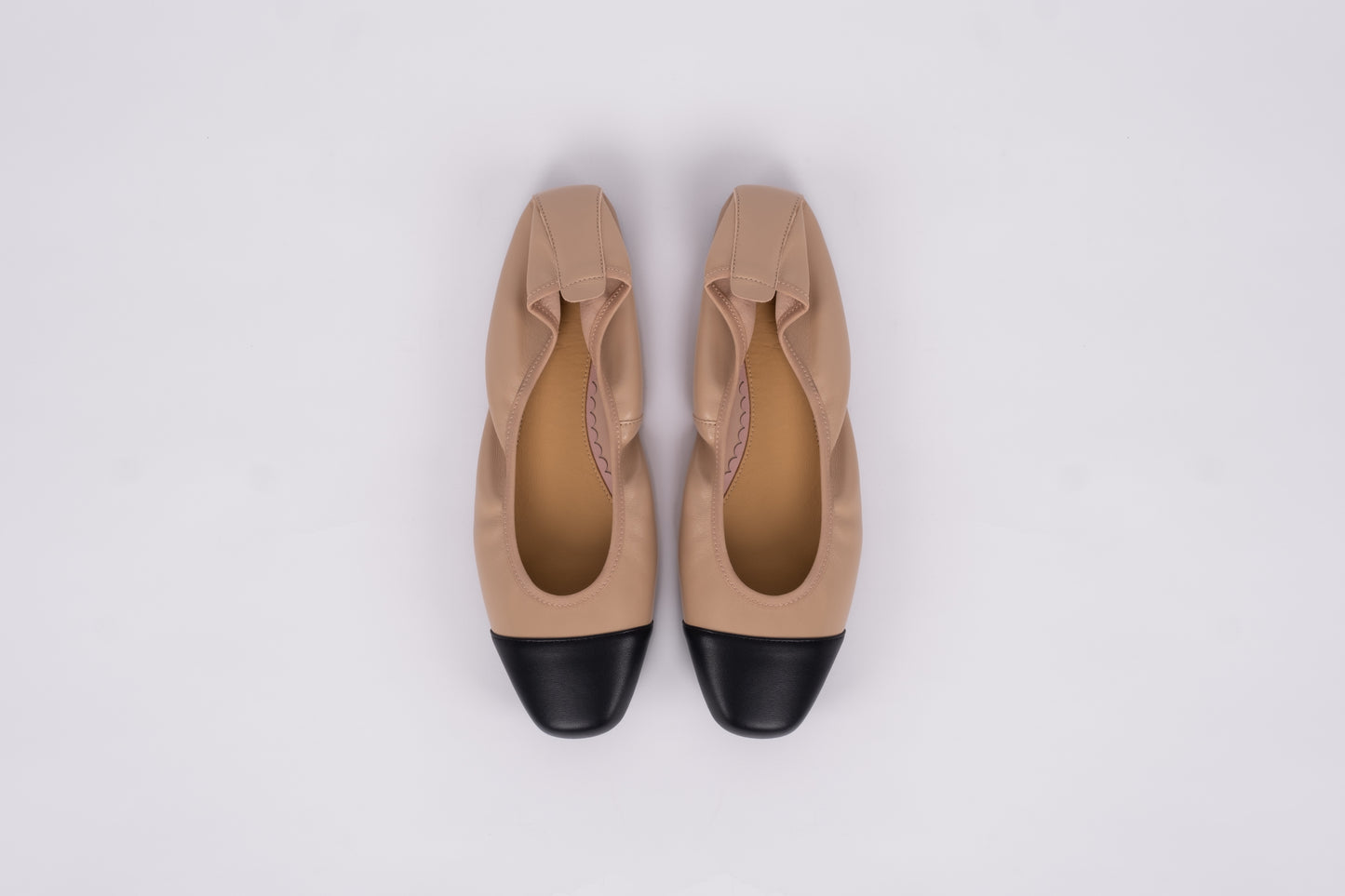 Aerial shot of womens beige and black womens flat shoe available in womens larger sizes euro 42-46