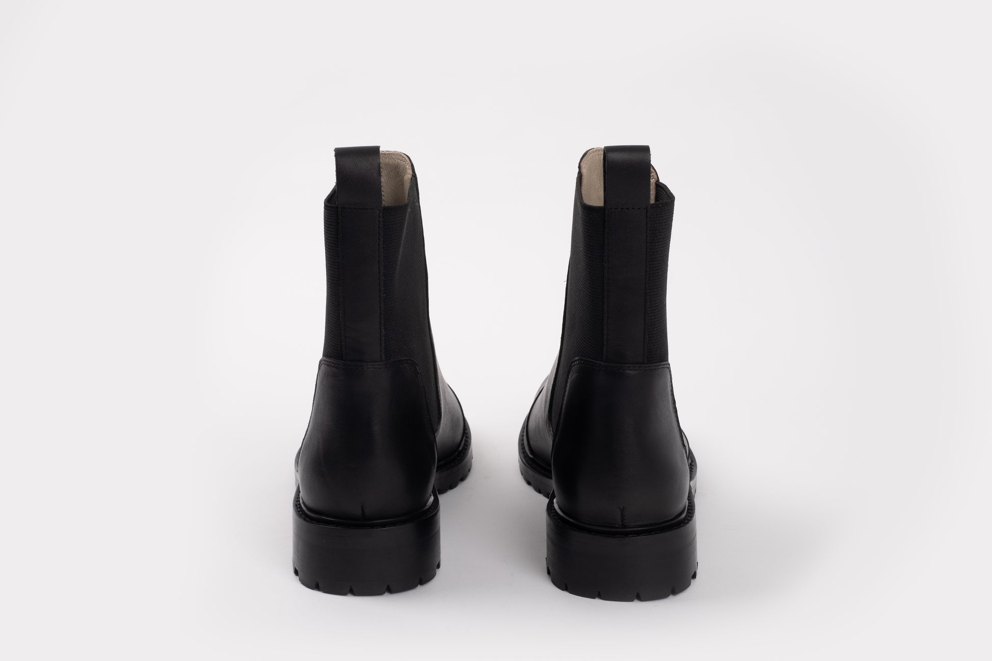 Alexa Boot by Otto + Ivy - a back profile of a black chelsea boot for tall women with large feet, featuring black elasticated sides.