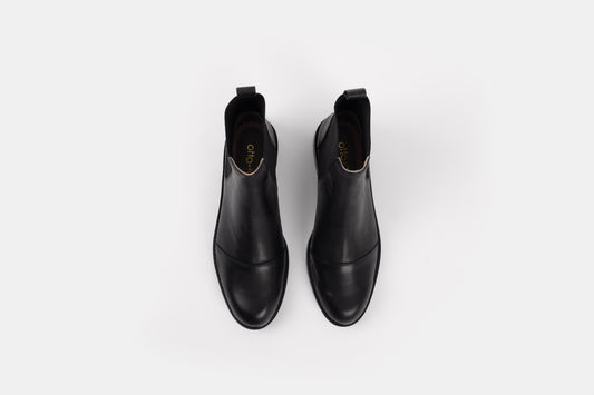 Alexa Boot by Otto + Ivy - an aerial profile of a black chelsea boot for tall women with large feet, featuring black elasticated sides.