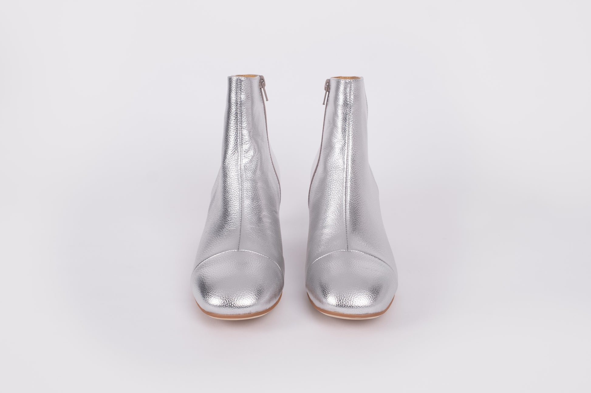 Izzy Boot by Otto + Ivy - a front profile of a silver boot for tall women with large feet, featuring silver leather and a low chunky heel.