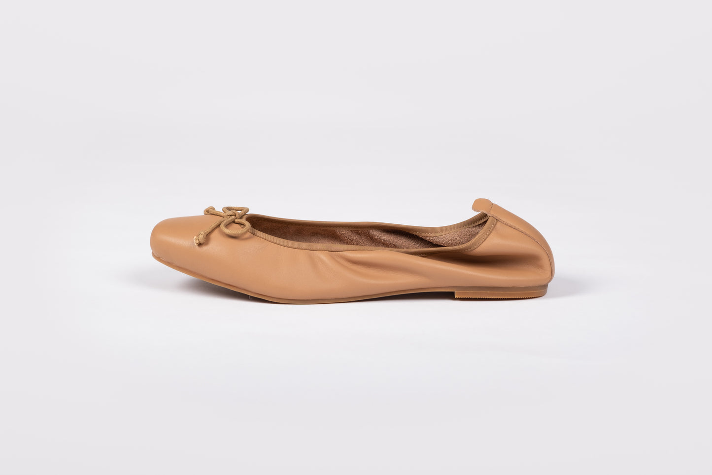 Side shot of Olivia Flat in Tan, and elasticated black flat shoe in womens larger UK sizes 8-12