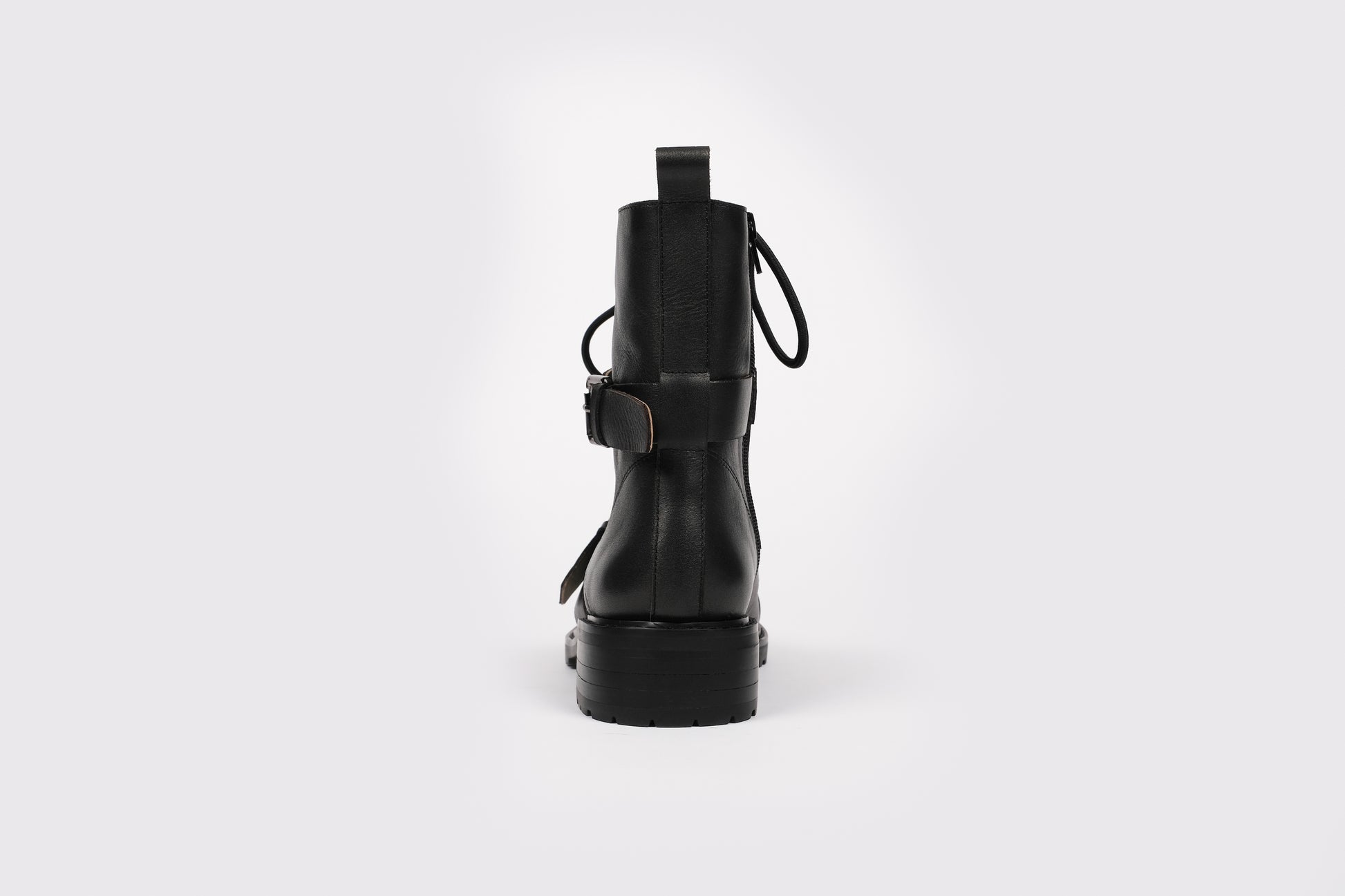 Maisie Boot by Otto and Ivy -  a back profile of a black biker boot for tall women with large feet, featuring silver buckles and black laces.