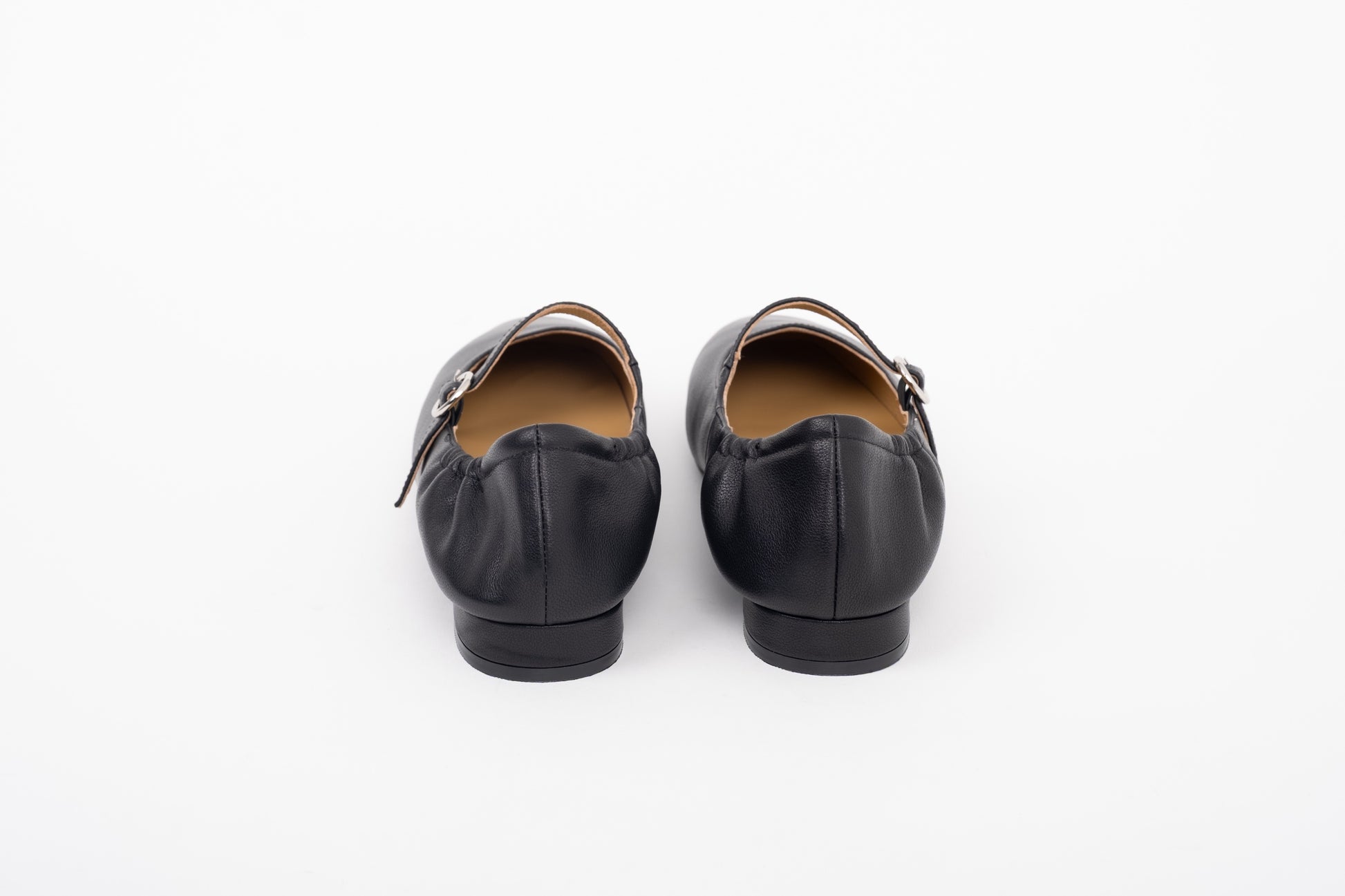 Back shot of womens black leather flat ne strap Mary Jane shoes in sizes 42 43 44 45 46