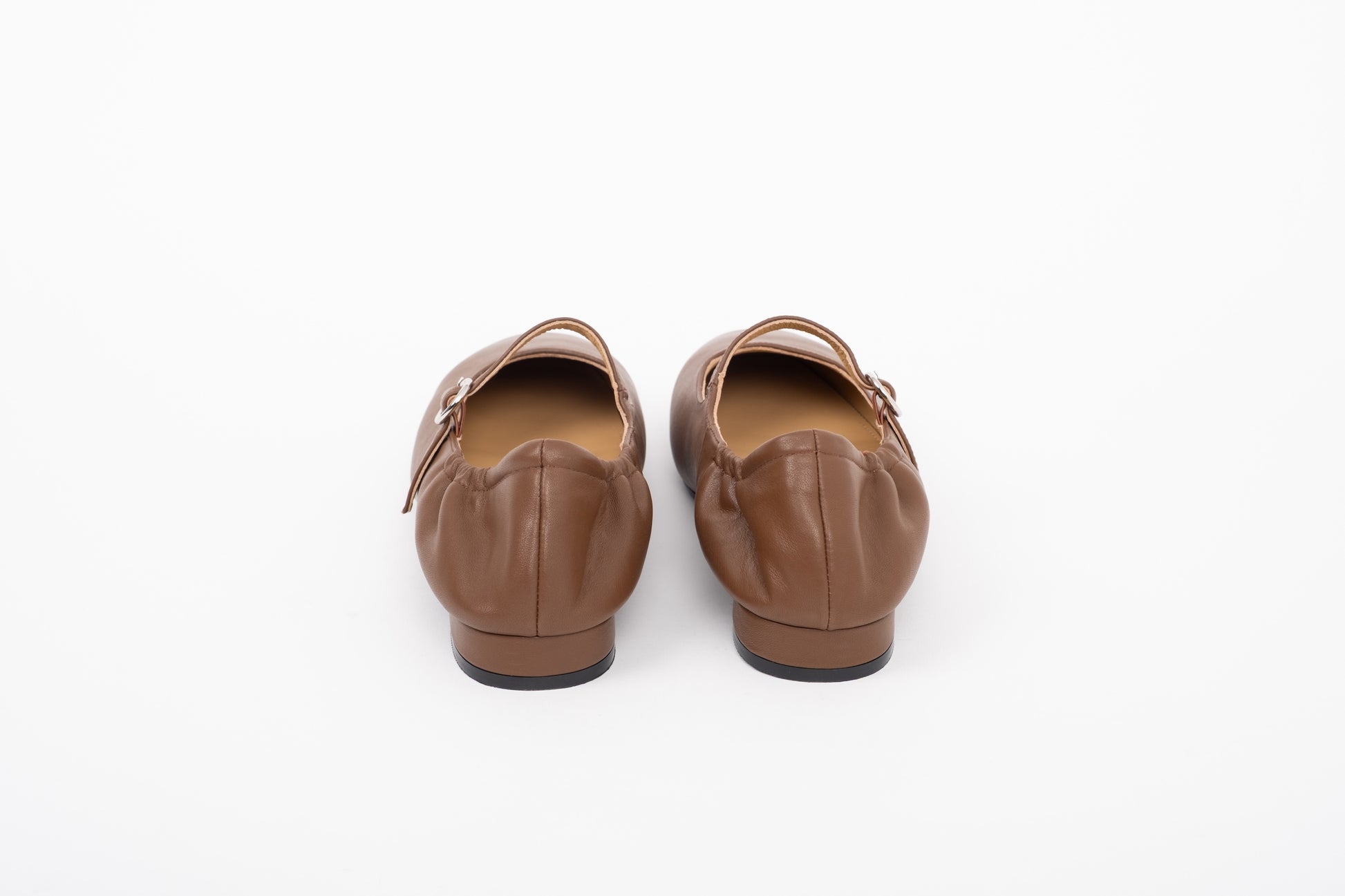 Back shot of leather brown womens large sized flat Mary Jane shoes in sizes 8 9 10 11 12