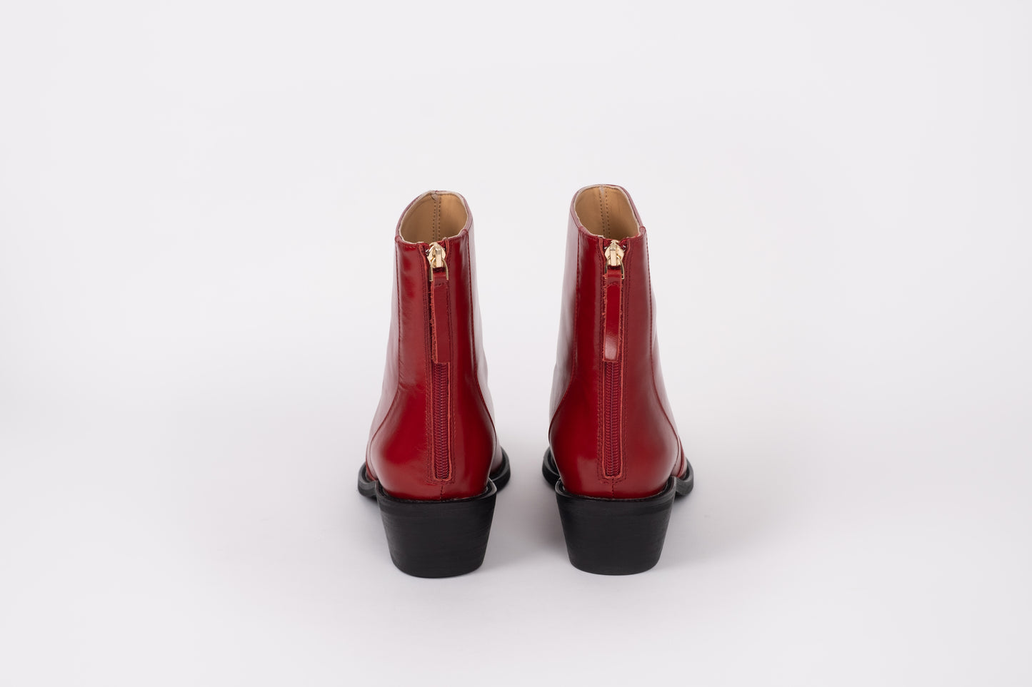 Back view of Phoebe boot displaying  zip. Red leather ankle boot available in womens sizes 8-12