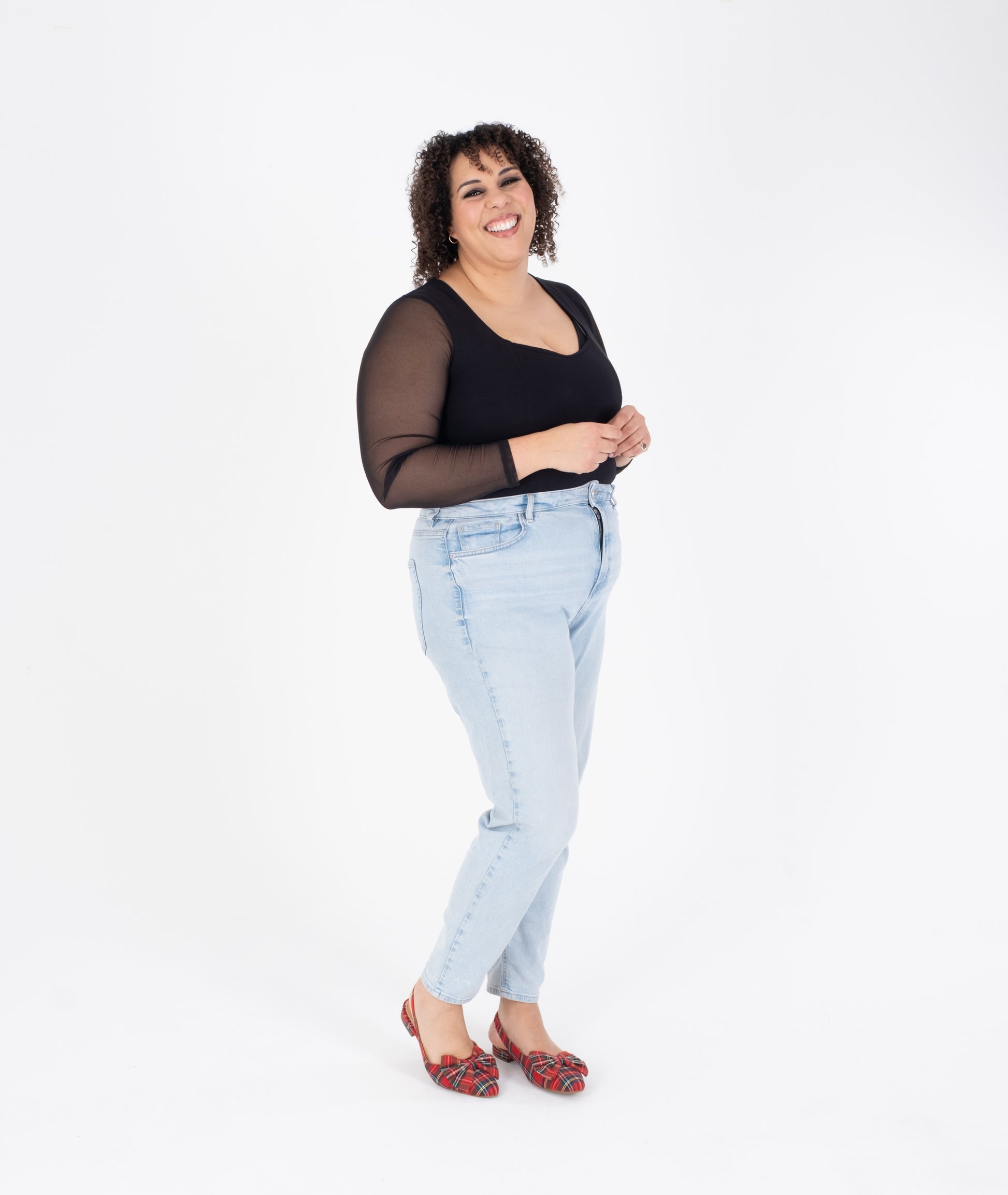 Tall woman modelling red tartan bow slingback flat shoes in larger sizes 42-46