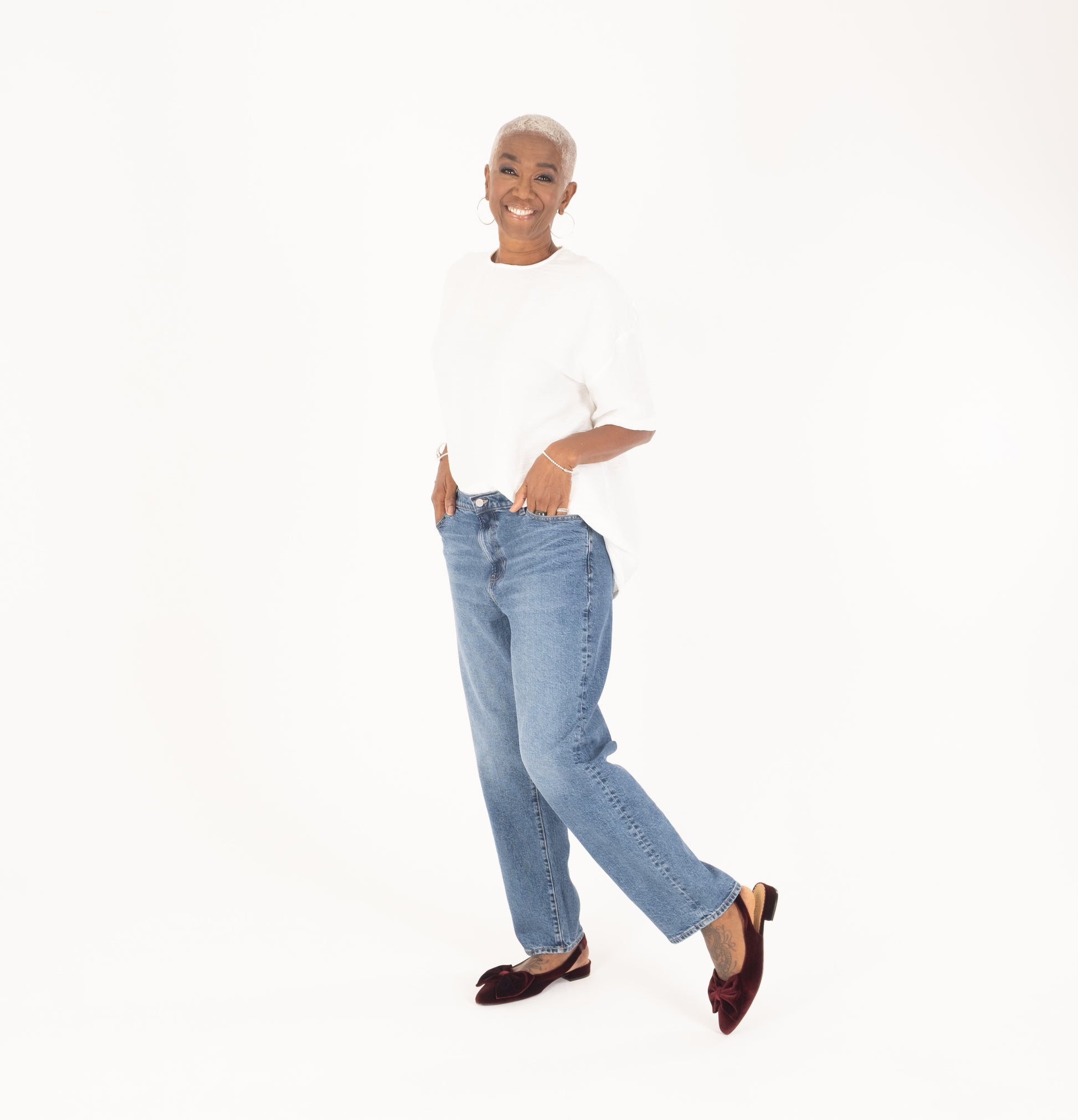 tall woman modelling burgundy velvet bow slingback flat shoes in larger sizes 8-12