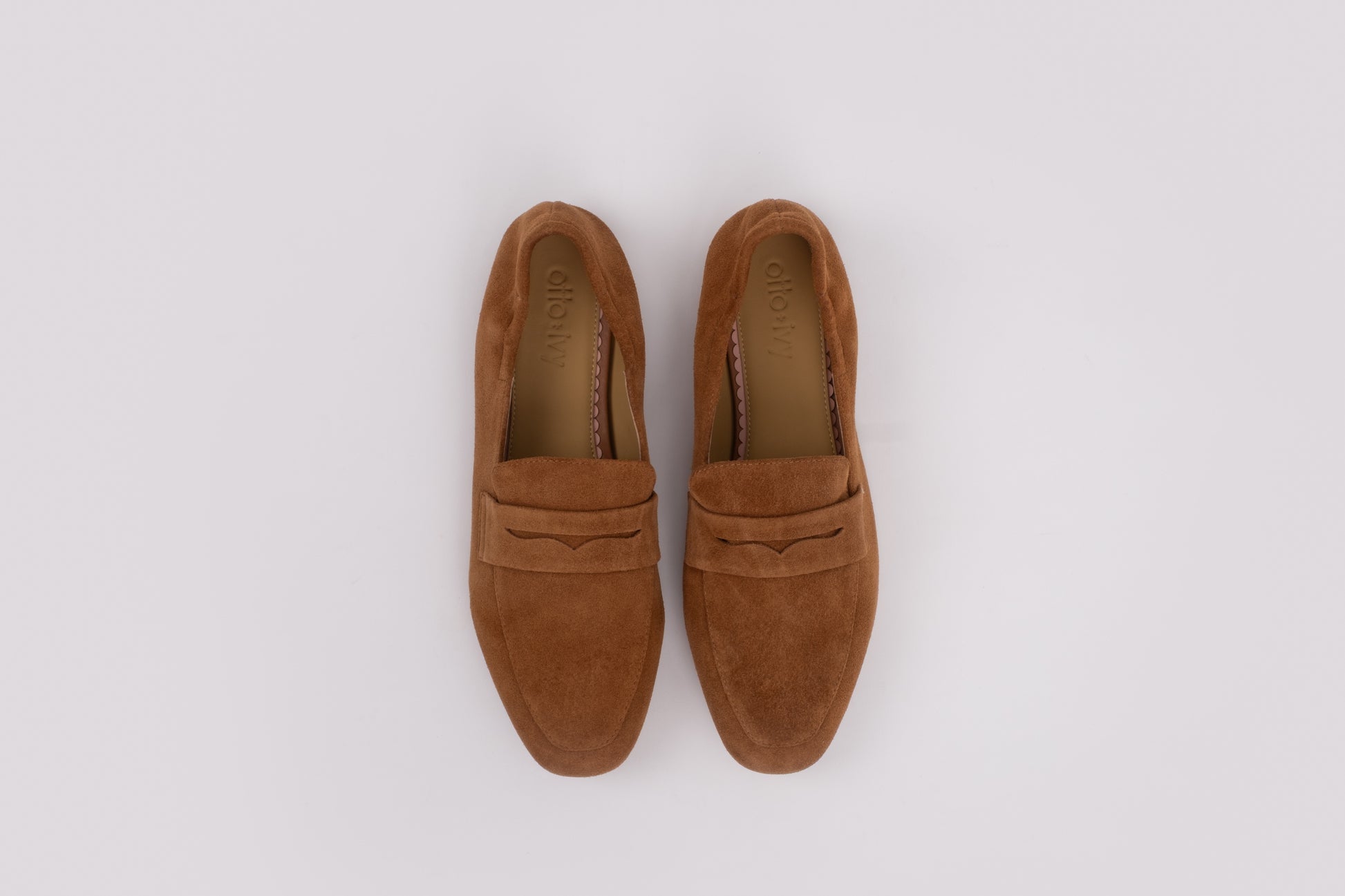 Large sized womens Pair of brown loafers on a white background