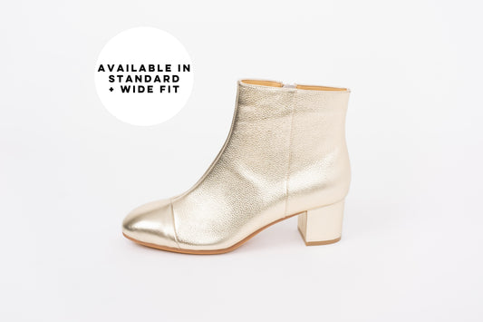 Side profile of Izzy Boot in Gold. A low heeled ankle boot available in larger womens UK sizes 8-12. Standard and wide fit.