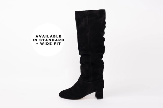 Side profile of Evelyn boot in black. A suede knee high boot with heel. Available in larger sizes 42-46