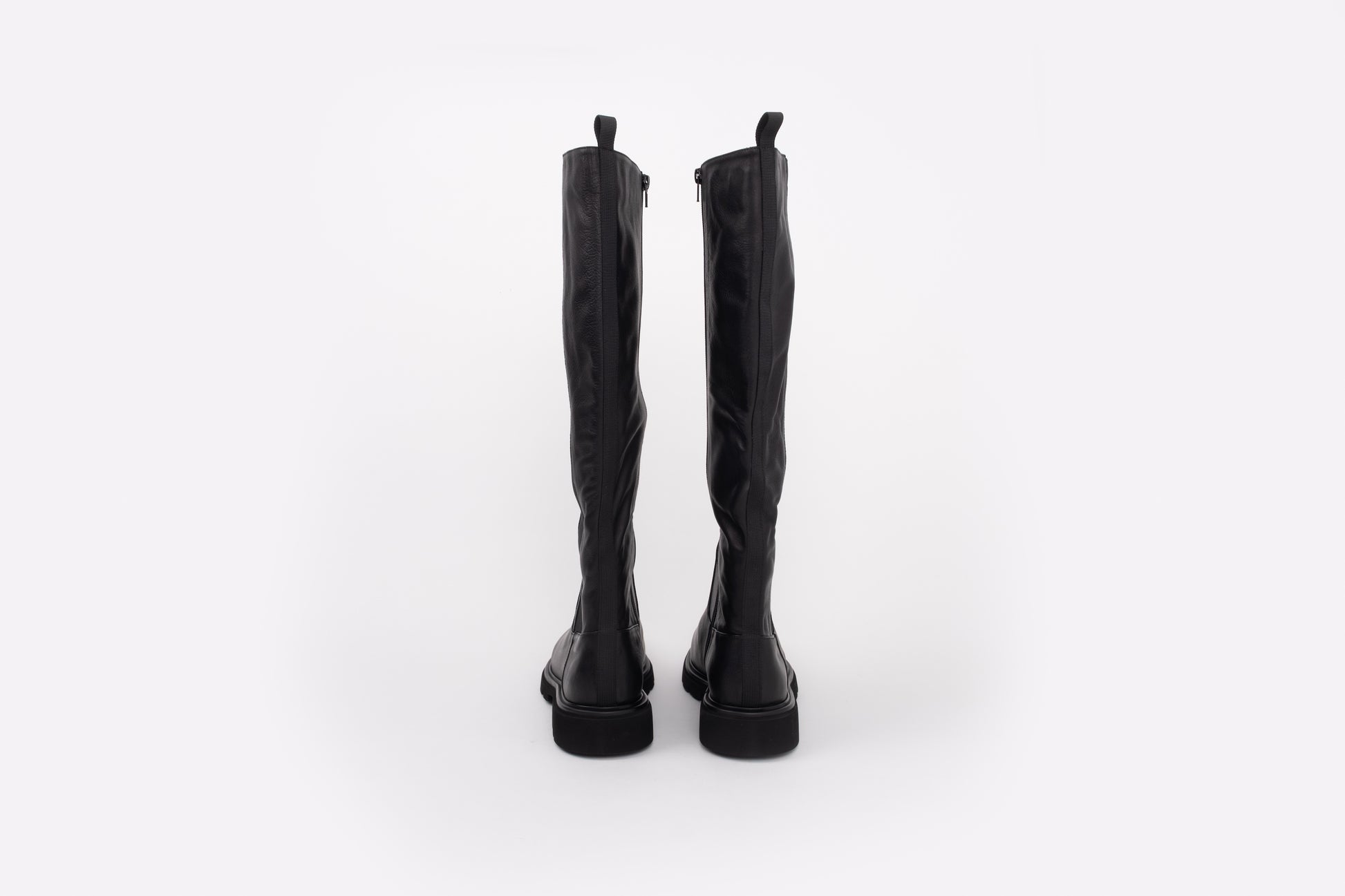 back shot of womens flat knee high leather boot available in larger sizes 8-12