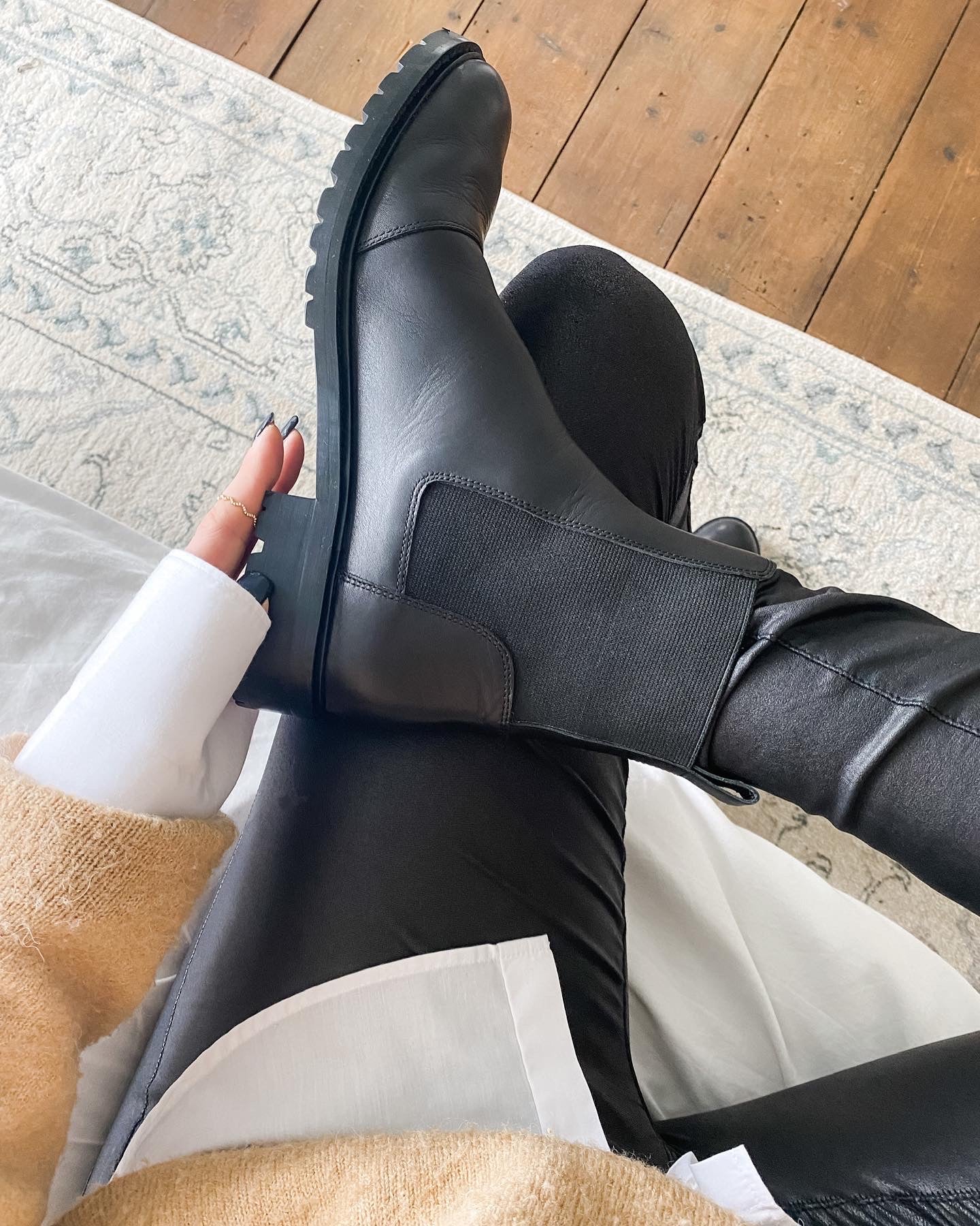 Alexa Boot by Otto + Ivy - a side profile of a black chelsea boot for tall women with large feet, featuring black elasticated sides, being worn by a tall model.