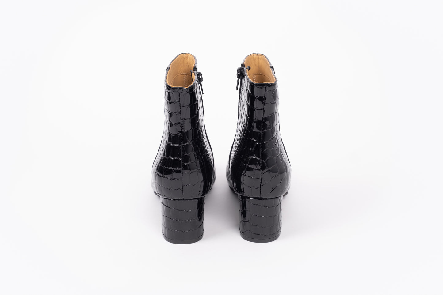 Izzy Boot by Otto + Ivy - a back profile of a black boot for tall women with large feet, featuring glossy black croc leather and a low chunky heel.