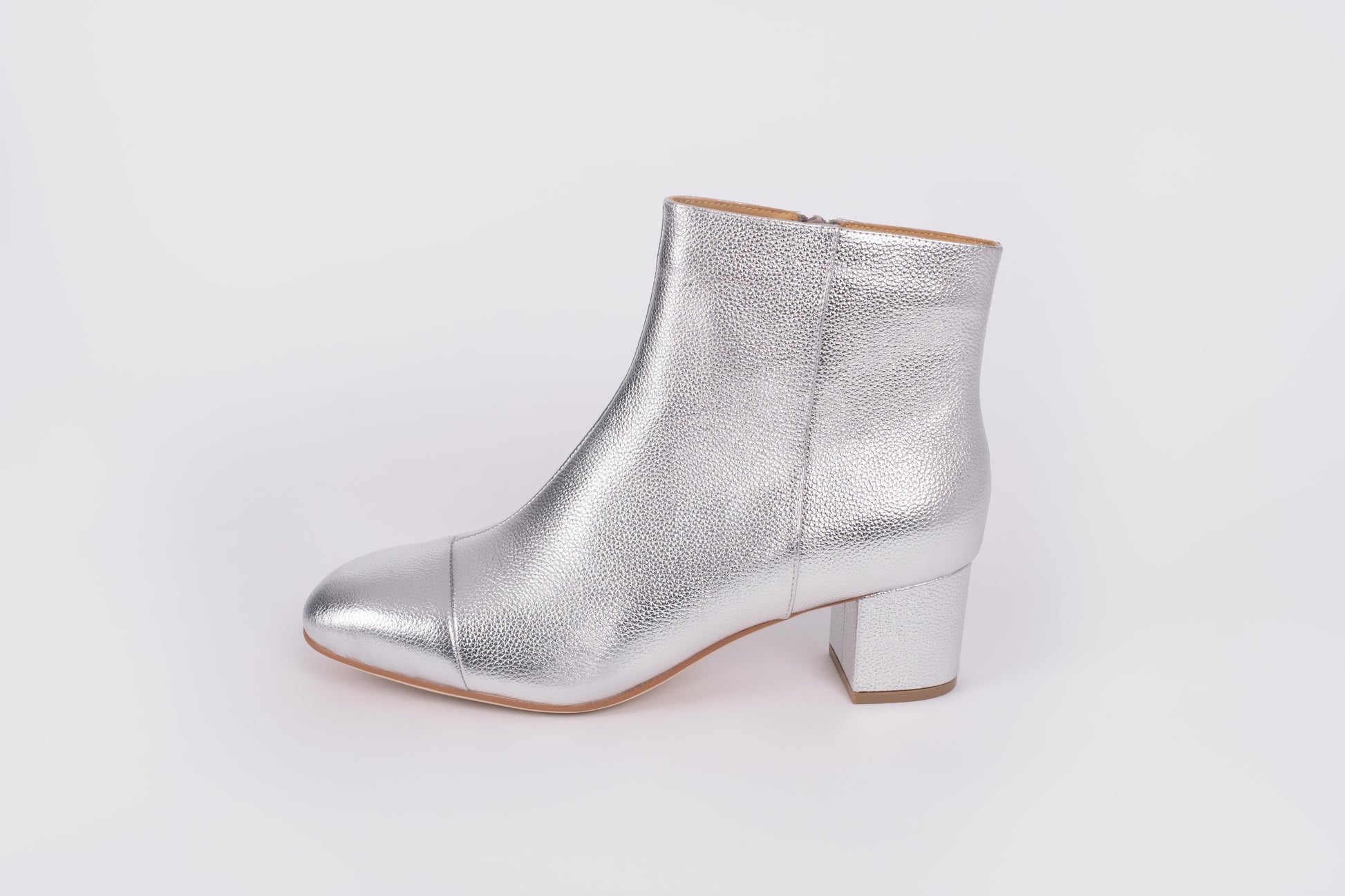 Izzy Boot by Otto + Ivy - a side profile of a silver boot for tall women with large feet, featuring silver leather and a low chunky heel.