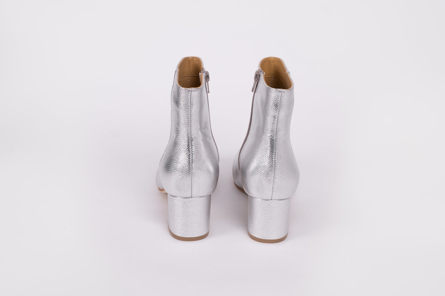Izzy Boot by Otto + Ivy - a back profile of a silver boot for tall women with large feet, featuring silver leather and a low chunky heel.
