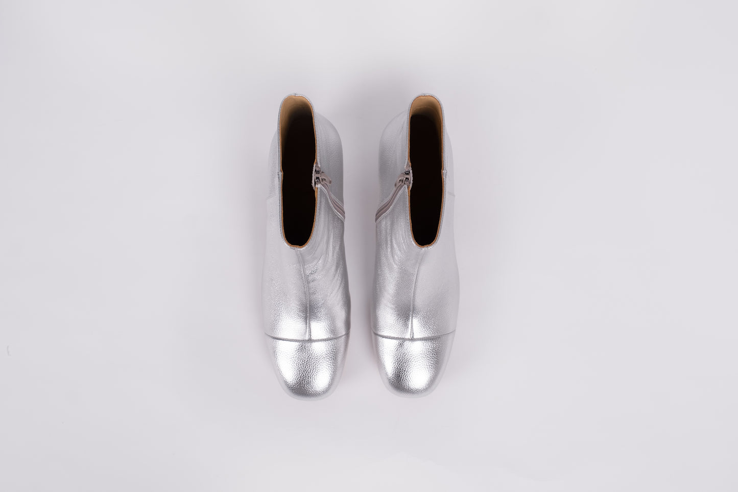 Izzy Boot by Otto + Ivy - an aerial profile of a silver boot for tall women with large feet, featuring silver leather and a low chunky heel.