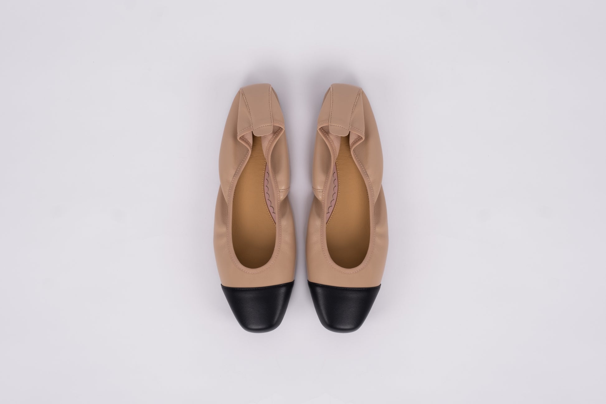 Aerial shot of womens beige and black womens flat shoe available in womens larger sizes euro 42-46