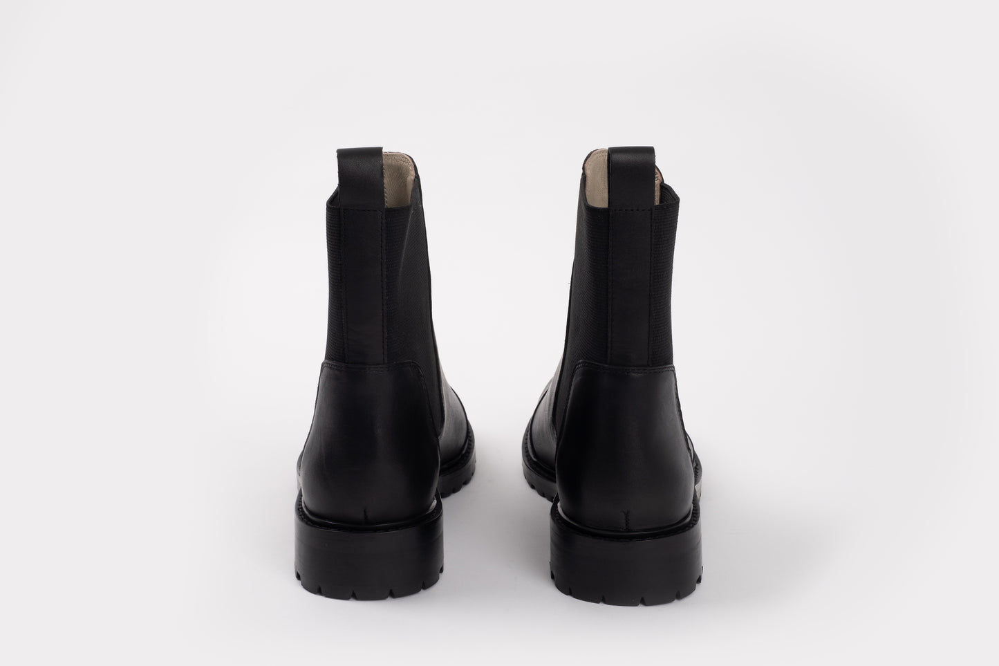 Alexa Boot by Otto + Ivy - a back profile of a black chelsea boot for tall women with large feet, featuring black elasticated sides. 