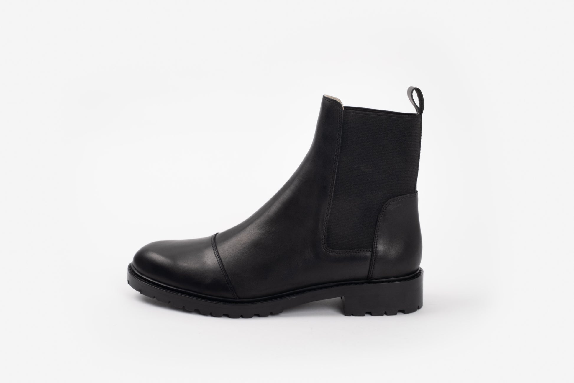 Alexa Boot by Otto + Ivy - a side profile of a black chelsea boot for tall women with large feet, featuring black elasticated sides. 