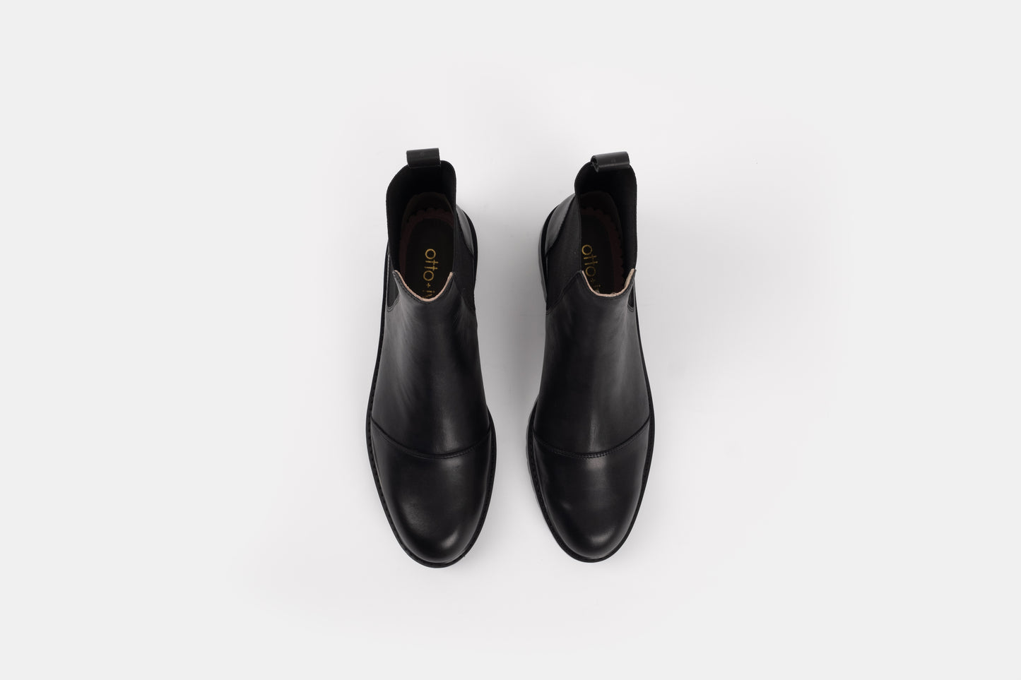 Alexa Boot by Otto + Ivy - an aerial profile of a black chelsea boot for tall women with large feet, featuring black elasticated sides. 