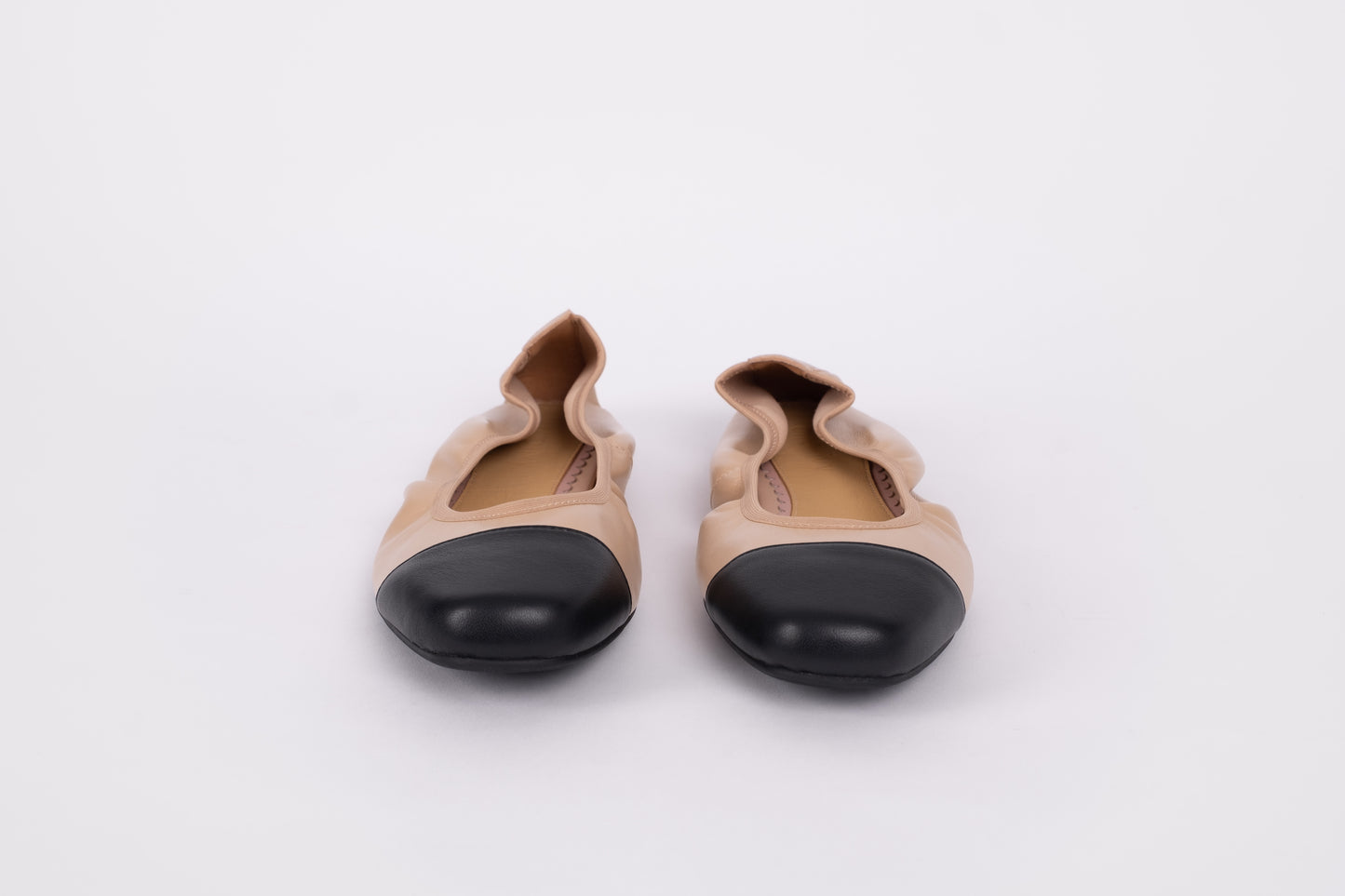 Front veiw of womens beige and black elasticated pumps available in euro sizes 42-46