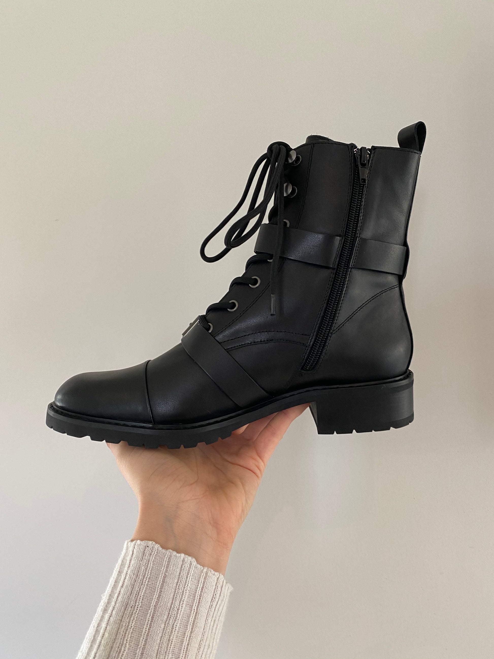Maisie Boot by Otto and Ivy -  a side profile of a black biker boot for tall women with large feet, featuring silver buckles, a side zip and black laces.