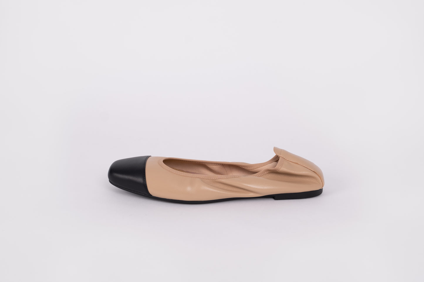 Side profile of beige and black flat ballet pumps available in larger sizes 8-12