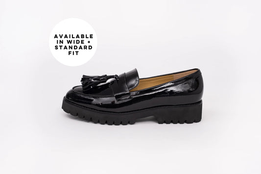 Side profile of Betsy Loafer in black. A Womens flat shoe with tassel on front, available in ladies large sizes 42-46, standard and wide fot.