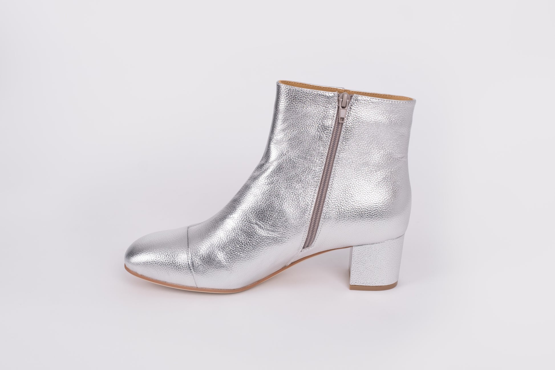 Izzy Boot by Otto + Ivy - a side profile of a silver boot for tall women with large feet, featuring silver leather, a side zip and a low chunky heel.